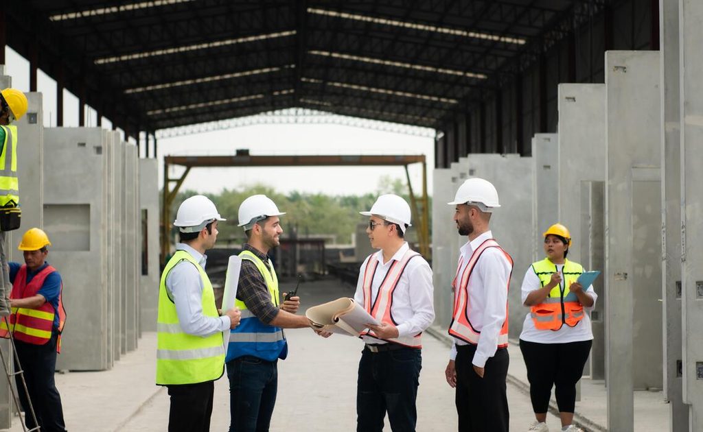construction workers on site visit shaking hands